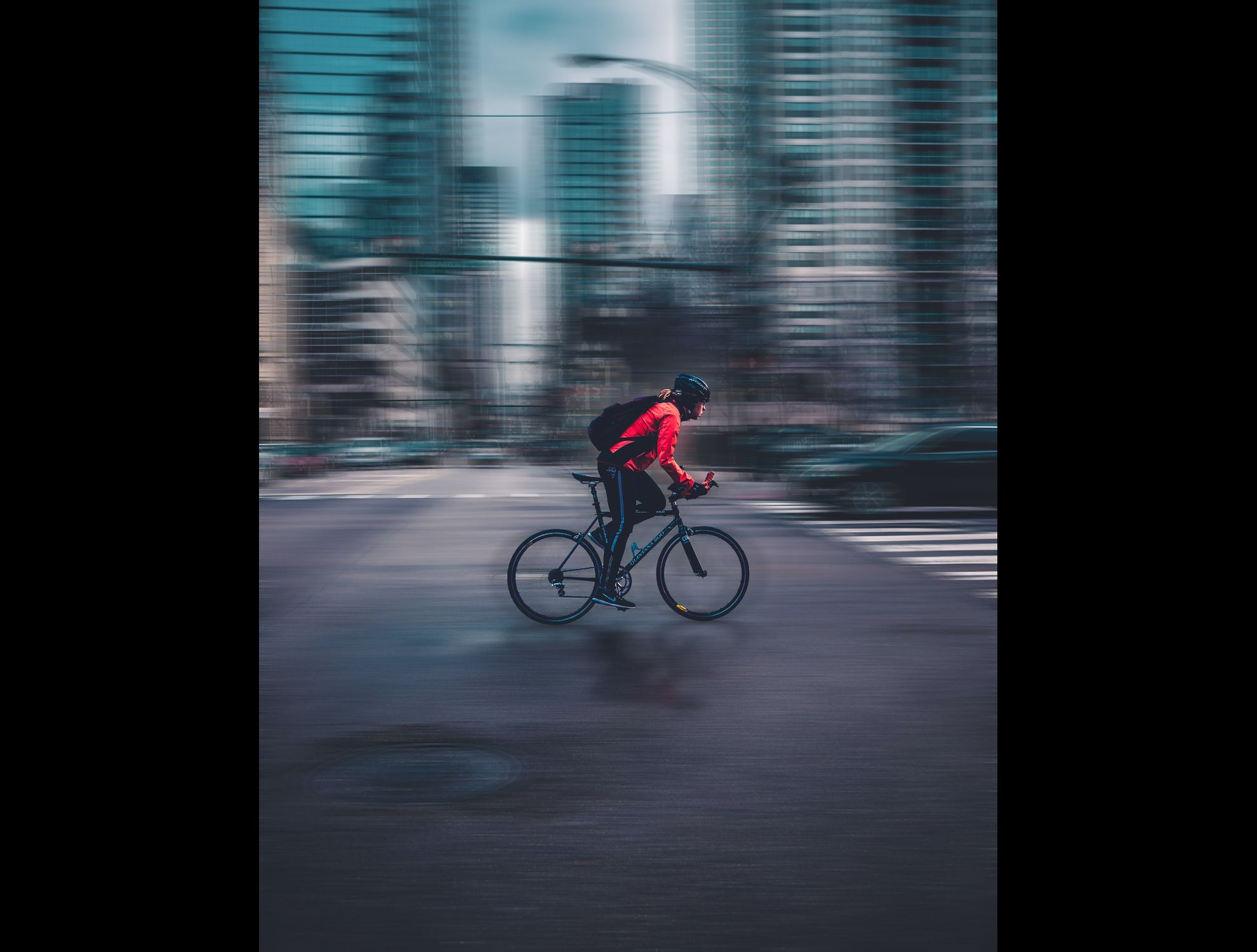 A person riding a bicycle on a street Description automatically generated with medium confidence